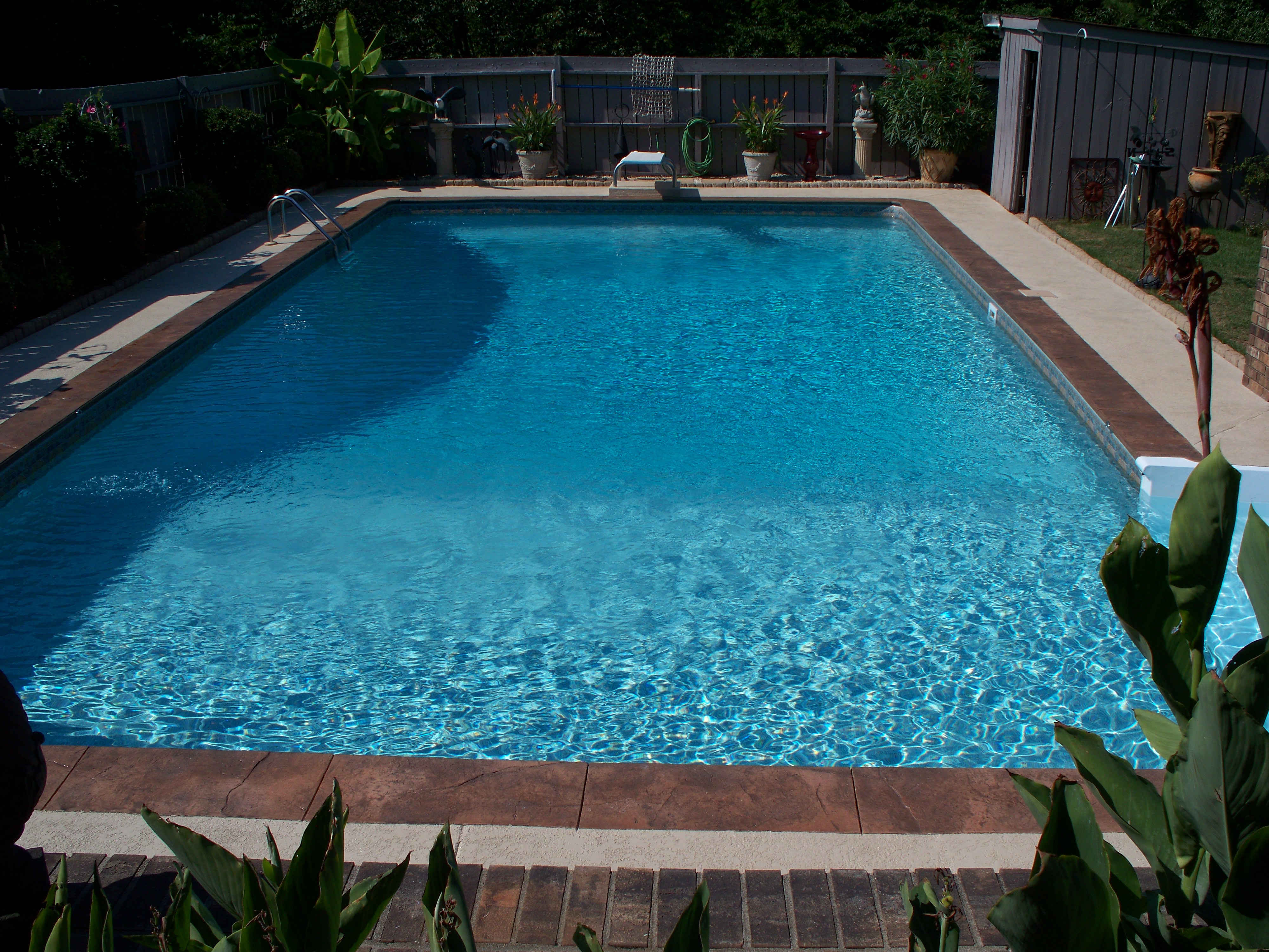 Vinyl liner being installed in an in-ground pool