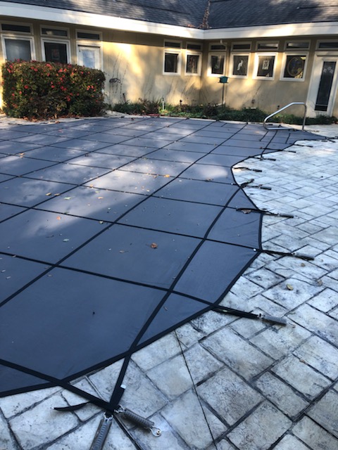 Pool safety cover installed for winterization in Auburn AL
