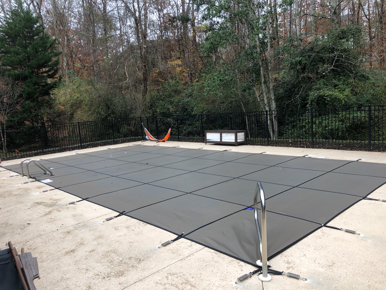 Custom-fit safety cover installed on irregularly shaped pool &mdash; Rao residence